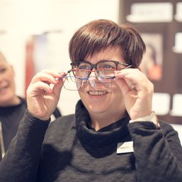 Dame prøver forskjellige brillemodeller hos Interoptikk Futura